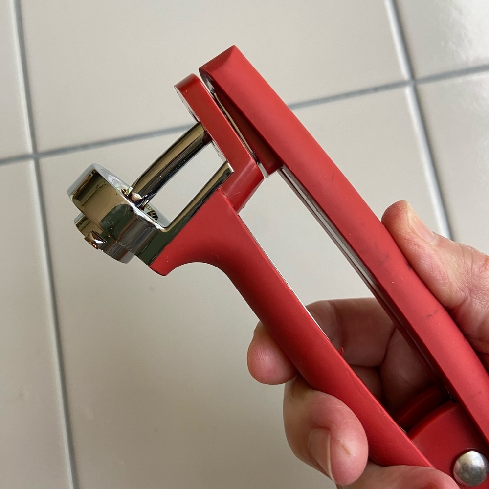 Red olive and cherry pitting tool